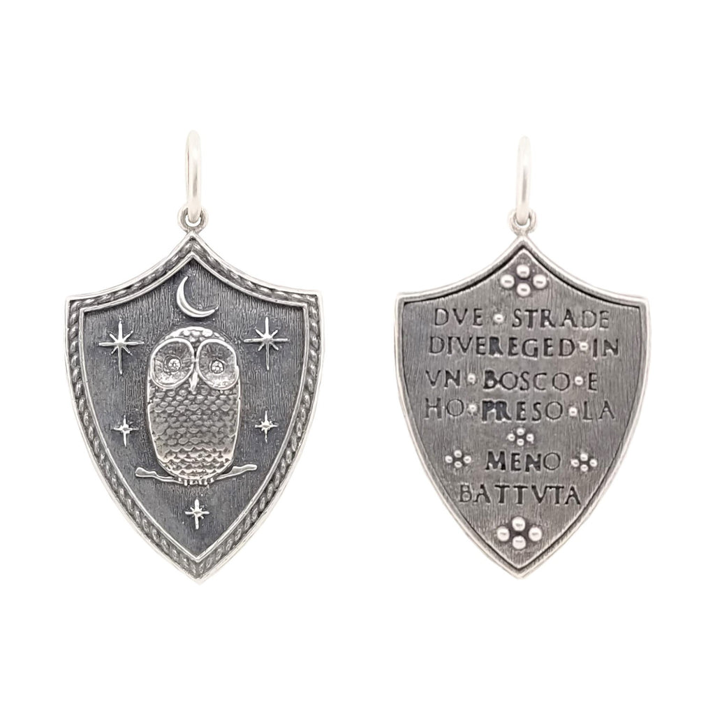 large shield with owl, moon & stars with diamond eyes .004cts  reads "Two roads diverged in a wood & I took the one less traveled" by Robert Frost shown in oxidized sterling silver #c195-2