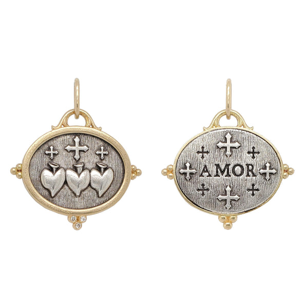 triple sacred heart + crosses double sided charm with white diamonds .015cts on heart side reads "love". Shown in oxidized sterling silver with 18k gold rim & bail #c314d