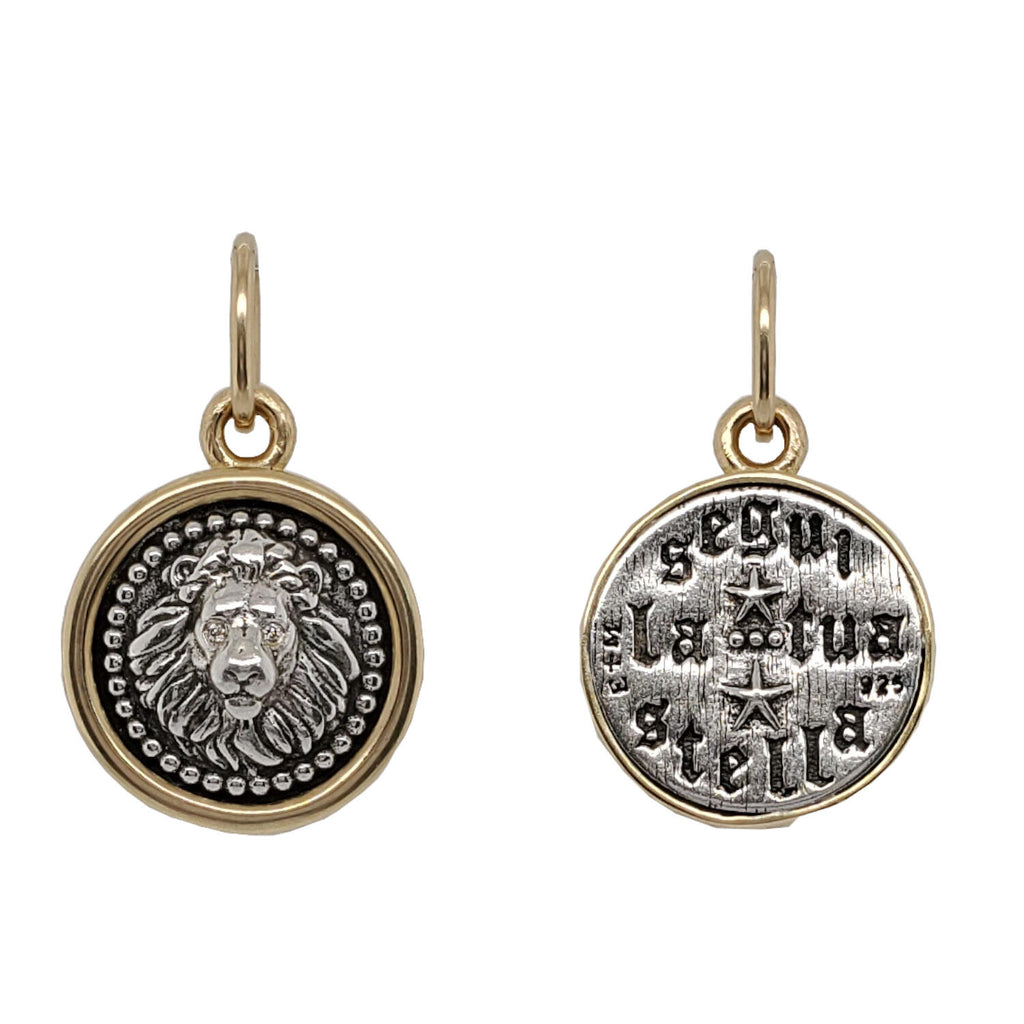 small round lion head double sided charm with white diamond .004cts eyes  reads "follow your own star" shown in oxidized sterling silver with 18k gold rim & bail  #c353d