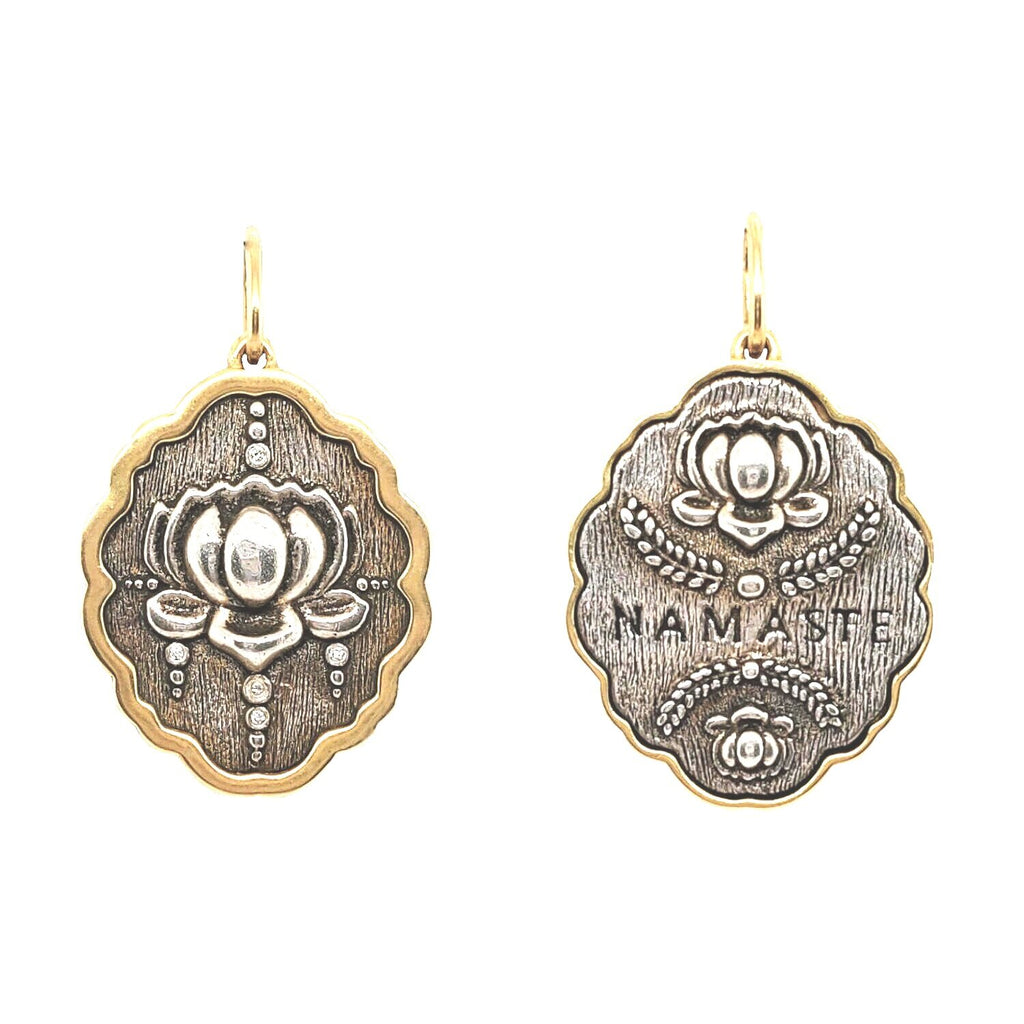 lotus double sided charm reads "namaste" sided charm with white diamonds .0125c on lotus side  shown in oxidized sterling silver with 18k gold rim & bail #c293d