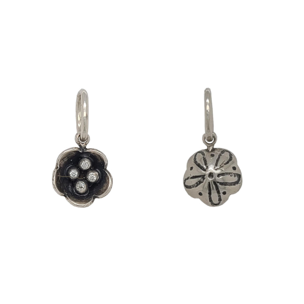 tiny double sided flower charm with white diamonds in the center .032cts shown  in oxidized sterling silver  #co30-2